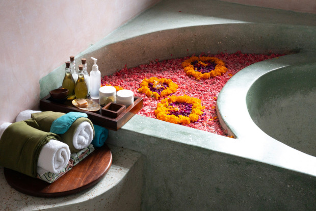 A bathtub filled with colorful flowers, creating a serene and inviting atmosphere.