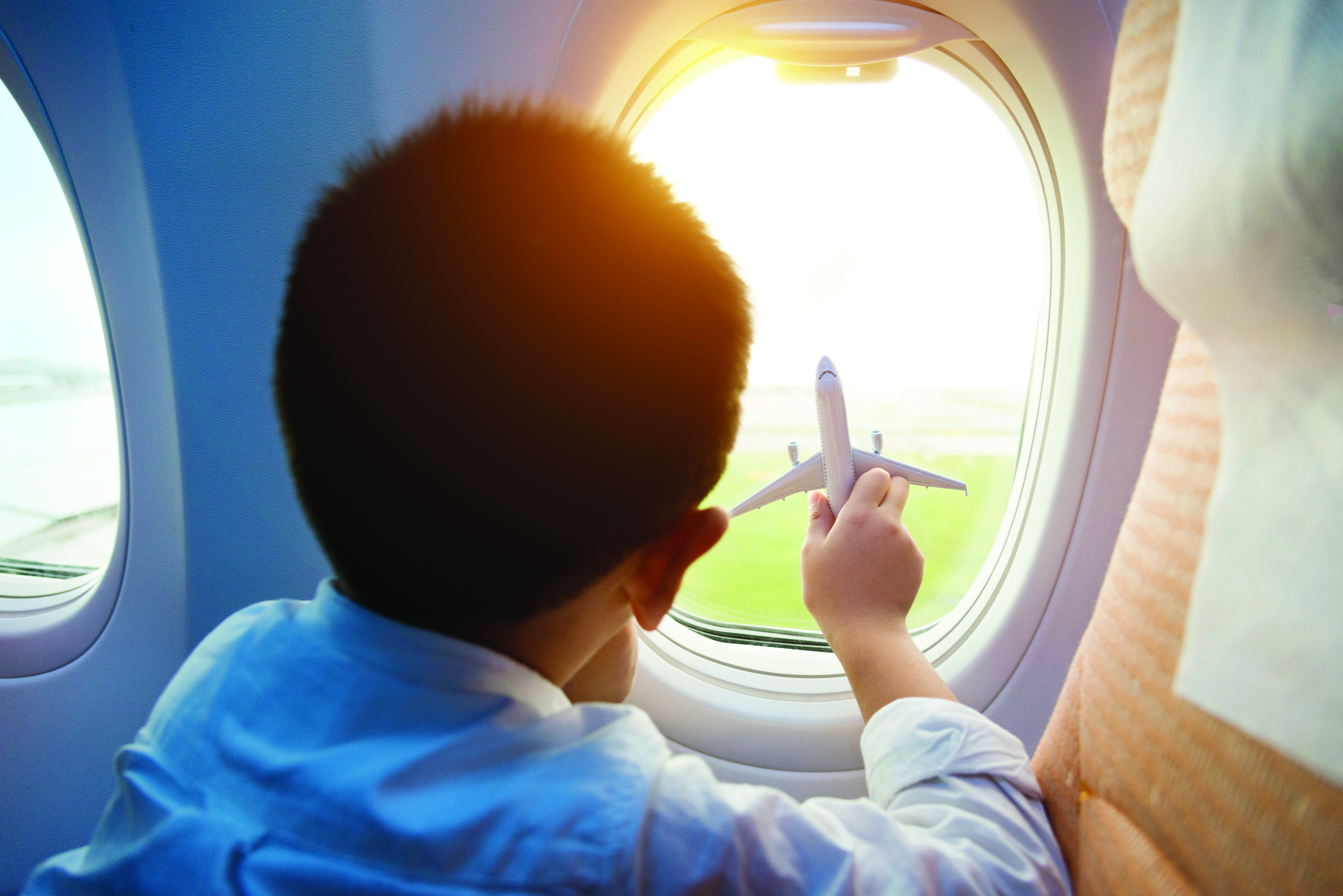 Little boy holding a toy plane